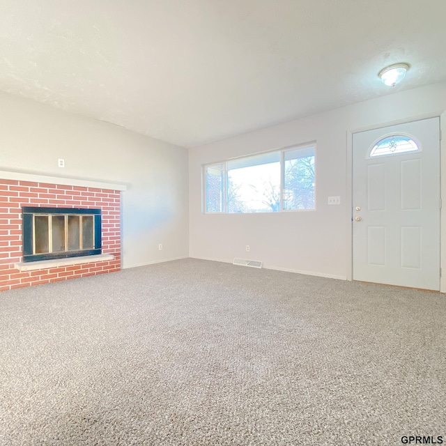 101 E 28th Ave, Bellevue, NE 68005 - unfurnished living room featuring healthy amount of natural light, carpet flooring, a fireplace, and baseboards