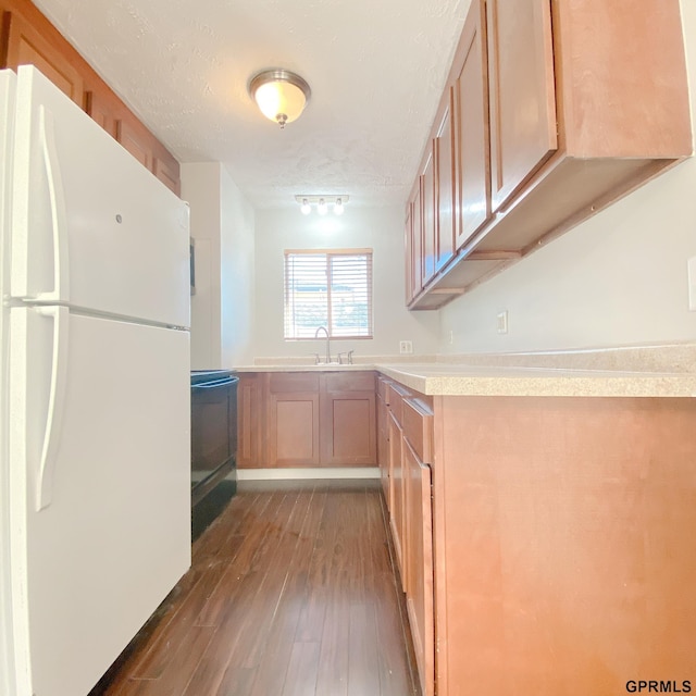 101 E 28th Ave, Bellevue, NE 68005 - kitchen featuring freestanding refrigerator, hardwood / wood-style flooring, stove, light countertops, and a textured ceiling