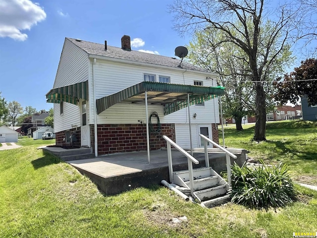 rear view of property with a yard, a chimney, and a shingled roof