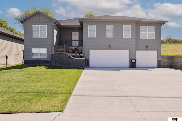 513 13th Ave, Plattsmouth, NE 68048 - view of front of property with a garage, concrete driveway, a front yard, stairway, and board and batten siding