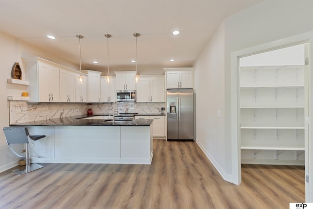 513 13th Ave, Plattsmouth, NE 68048 - kitchen with stainless steel appliances, open shelves, dark countertops, a peninsula, and white cabinets