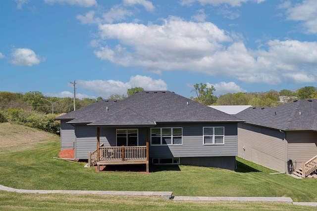 513 13th Ave, Plattsmouth, NE 68048 - rear view of property featuring a lawn, a wooden deck, and a shingled roof