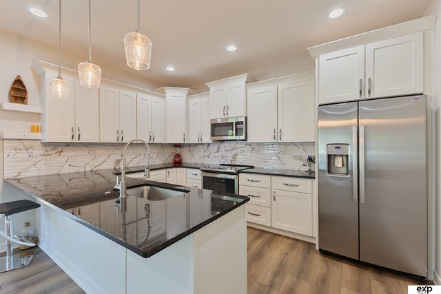 513 13th Ave, Plattsmouth, NE 68048 - kitchen with stainless steel appliances, a sink, open shelves, white cabinets, and recessed lighting