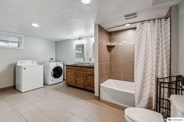 bathroom with washer and clothes dryer, toilet, shower / tub combo, a textured ceiling, and vanity
