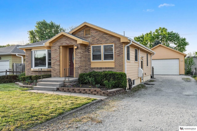 ranch-style home with an outdoor structure, brick siding, a garage, and a front yard