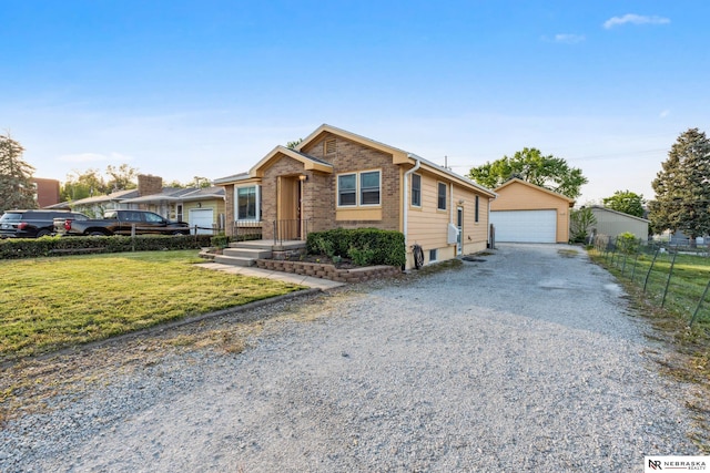 ranch-style house with a detached garage, an outbuilding, and brick siding