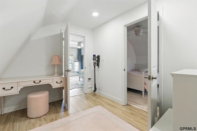 bathroom with ensuite bath, wood finished floors, lofted ceiling, baseboards, and recessed lighting
