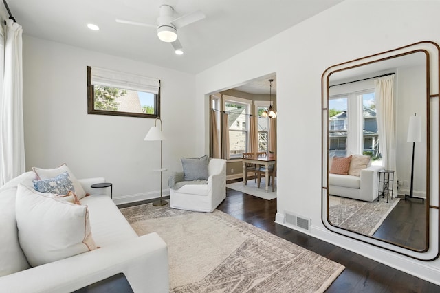 living room with a chandelier, wood finished floors, recessed lighting, a ceiling fan, and baseboards