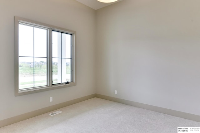 carpeted spare room with baseboards