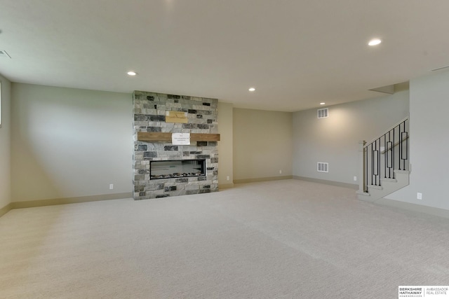 finished basement with recessed lighting, a fireplace, stairway, carpet floors, and baseboards