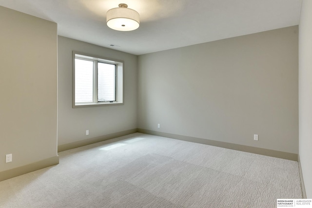 spare room with carpet floors and baseboards