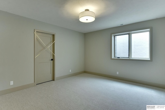 empty room with light colored carpet and baseboards