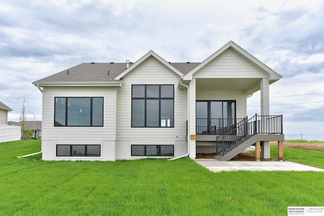 back of property featuring a yard and stairway