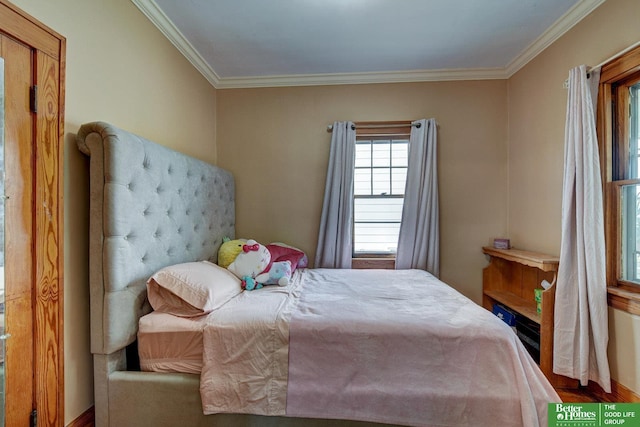 4939 Hickory St, Omaha, NE 68106 - bedroom with crown molding, wood finished floors, and baseboards