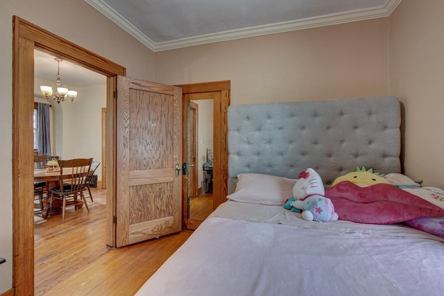 4939 Hickory St, Omaha, NE 68106 - bedroom with light wood-style flooring, ornamental molding, and a chandelier