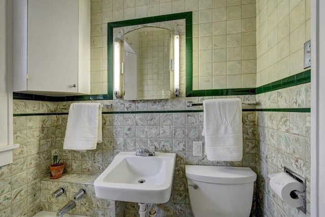 4939 Hickory St, Omaha, NE 68106 - bathroom featuring toilet, tile walls, and a sink
