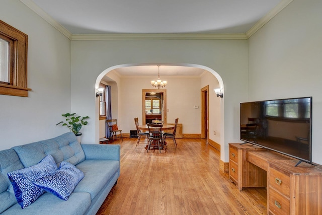 4939 Hickory St, Omaha, NE 68106 - living room with light wood-style flooring, arched walkways, baseboards, ornamental molding, and a chandelier