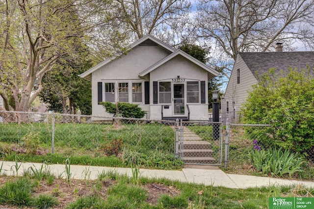 4939 Hickory St, Omaha, NE 68106 - bungalow-style house with a gate, stucco siding, and a fenced front yard