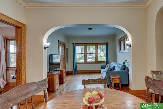 4939 Hickory St, Omaha, NE 68106 - dining room with arched walkways, crown molding, wood finished floors, and baseboards