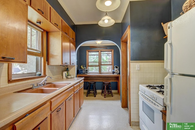 4939 Hickory St, Omaha, NE 68106 - kitchen with white appliances, a sink, light countertops, ornamental molding, and brown cabinetry