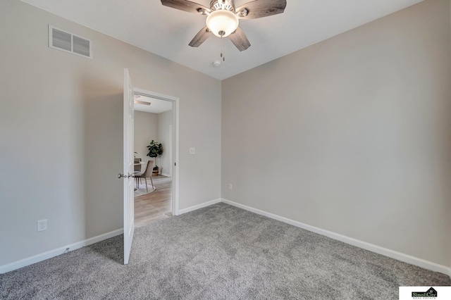 927 Garfield St, Lincoln, NE 68502 - unfurnished bedroom featuring light carpet, baseboards, and ceiling fan