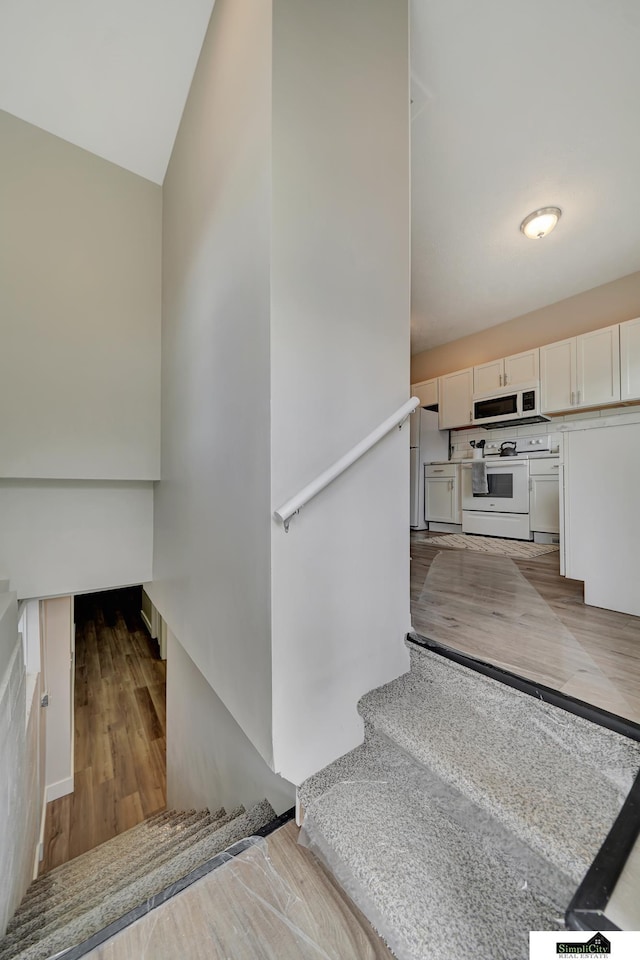 927 Garfield St, Lincoln, NE 68502 - stairs with wood finished floors and vaulted ceiling
