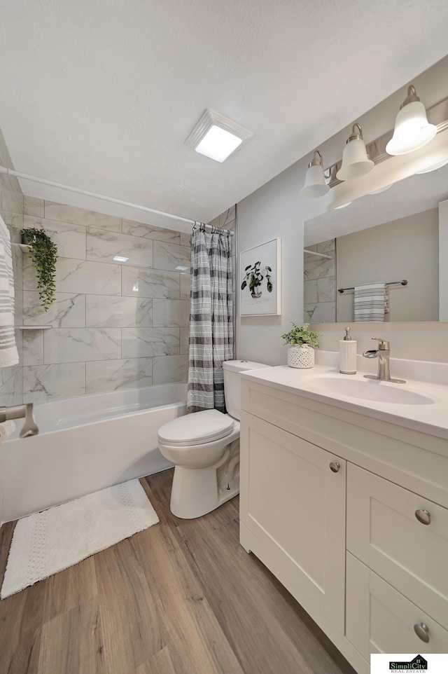 927 Garfield St, Lincoln, NE 68502 - full bath featuring toilet, wood finished floors, shower / tub combo with curtain, and vanity