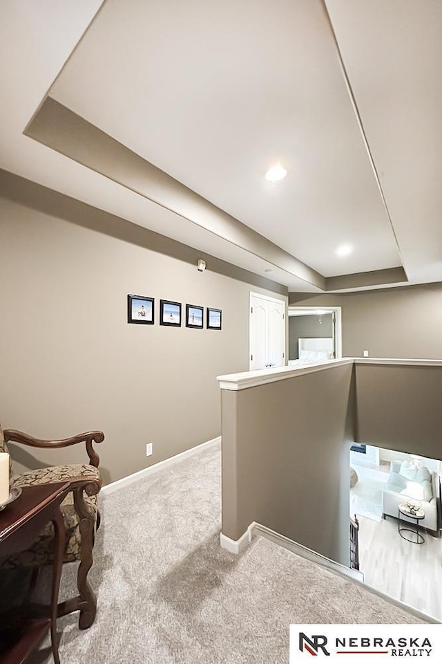 finished below grade area featuring baseboards and carpet floors