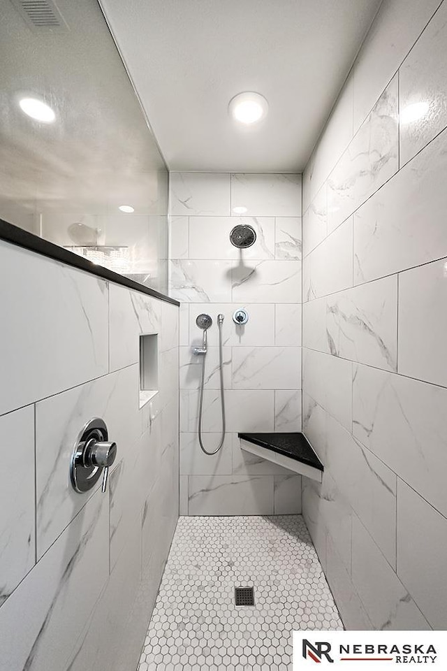 full bath featuring a tile shower and pet washing area