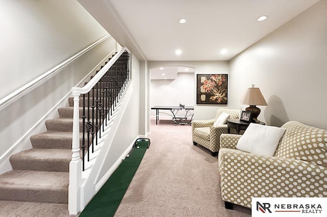 living room featuring carpet flooring, recessed lighting, stairway, arched walkways, and baseboards