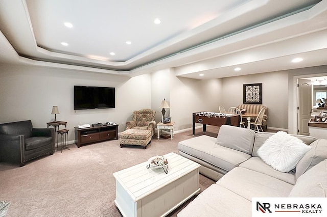 carpeted living room featuring recessed lighting, baseboards, and a raised ceiling