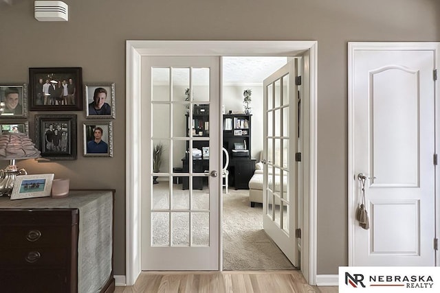 doorway to outside with light wood-style flooring and french doors
