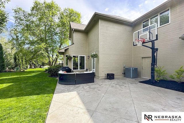 back of property with a patio, a lawn, outdoor lounge area, and central AC