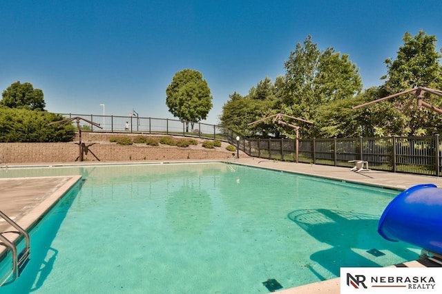 view of pool featuring fence