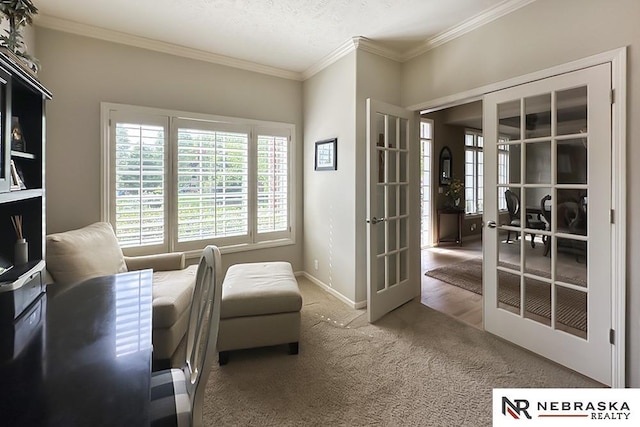living area with plenty of natural light, crown molding, carpet floors, baseboards, and french doors