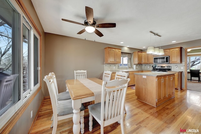 4630 Eagle Ridge Rd, Lincoln, NE 68516 - dining room with healthy amount of natural light, light wood-style floors, a ceiling fan, and recessed lighting