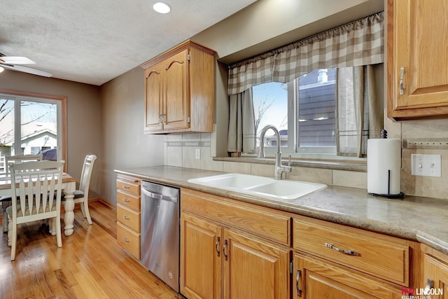 4630 Eagle Ridge Rd, Lincoln, NE 68516 - kitchen featuring stainless steel dishwasher, a sink, ceiling fan, light wood-type flooring, and a textured ceiling