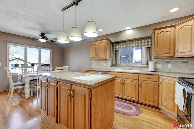 4630 Eagle Ridge Rd, Lincoln, NE 68516 - kitchen with a sink, electric stove, light countertops, a kitchen island, and a textured ceiling