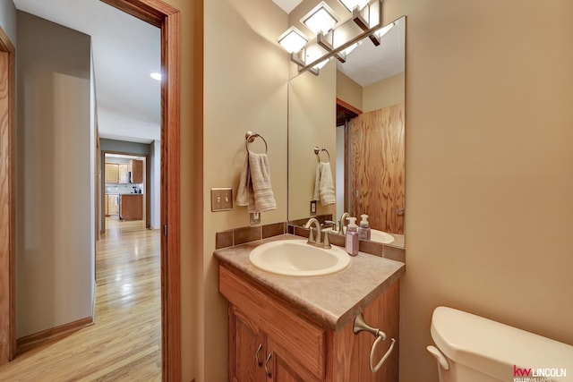 4630 Eagle Ridge Rd, Lincoln, NE 68516 - bathroom featuring toilet, wood finished floors, and vanity