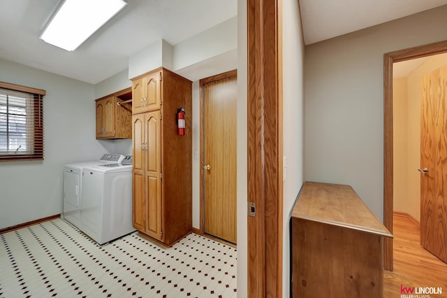 4630 Eagle Ridge Rd, Lincoln, NE 68516 - clothes washing area with cabinet space, separate washer and dryer, light flooring, and baseboards