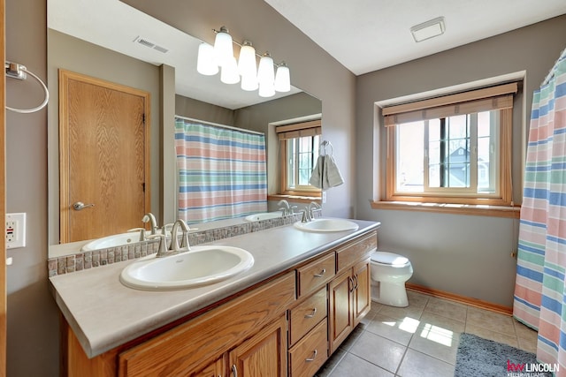 4630 Eagle Ridge Rd, Lincoln, NE 68516 - full bathroom with plenty of natural light, double vanity, tile patterned floors, and baseboards