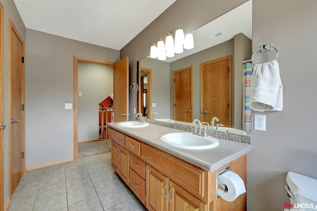 4630 Eagle Ridge Rd, Lincoln, NE 68516 - bathroom featuring tile patterned floors, double vanity, toilet, baseboards, and tasteful backsplash