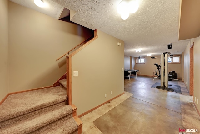4630 Eagle Ridge Rd, Lincoln, NE 68516 - basement featuring a textured ceiling, stairs, and baseboards