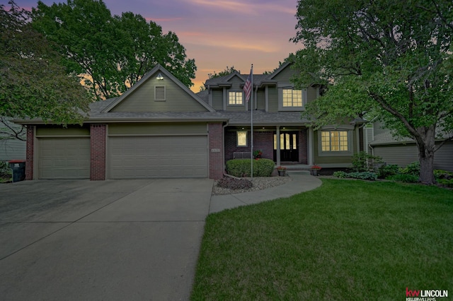 4630 Eagle Ridge Rd, Lincoln, NE 68516 - traditional-style house featuring a garage, concrete driveway, a front lawn, and brick siding