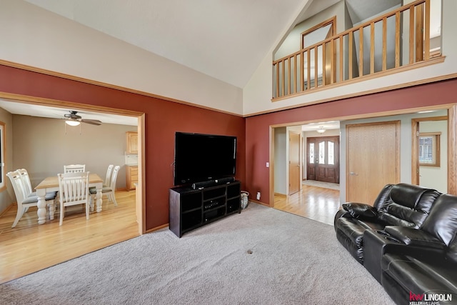 4630 Eagle Ridge Rd, Lincoln, NE 68516 - living room with carpet floors, a ceiling fan, high vaulted ceiling, baseboards, and wood finished floors