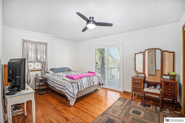 bedroom with access to exterior, wood finished floors, and ceiling fan