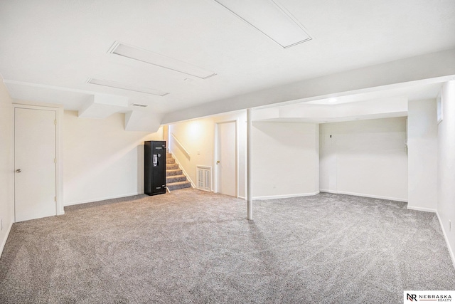 finished below grade area with carpet flooring, stairs, and baseboards