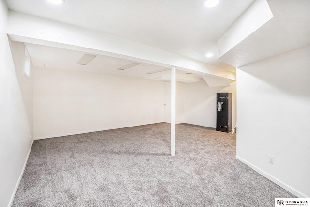 finished below grade area featuring carpet, recessed lighting, and baseboards