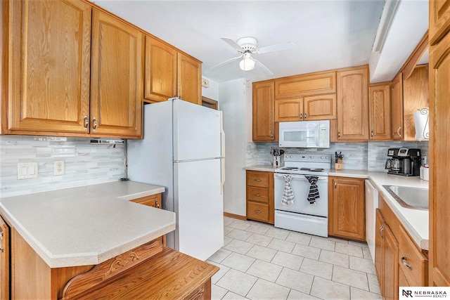 kitchen featuring white appliances, tasteful backsplash, a sink, ceiling fan, and light countertops