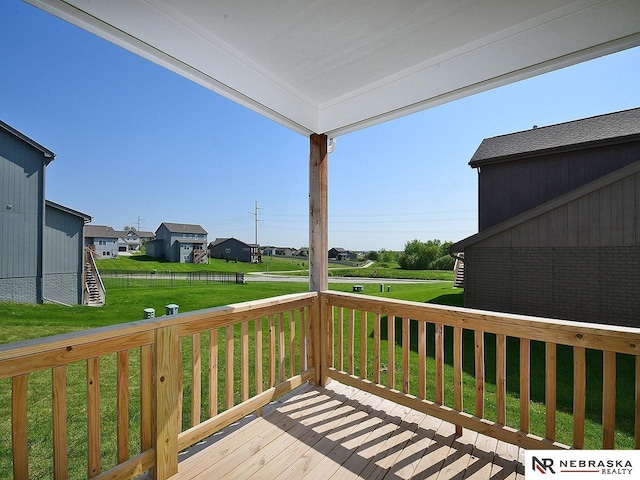 wooden deck with a yard, a residential view, and stairway